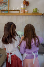 Load image into Gallery viewer, Two children in aprons standing in a kitchen.
